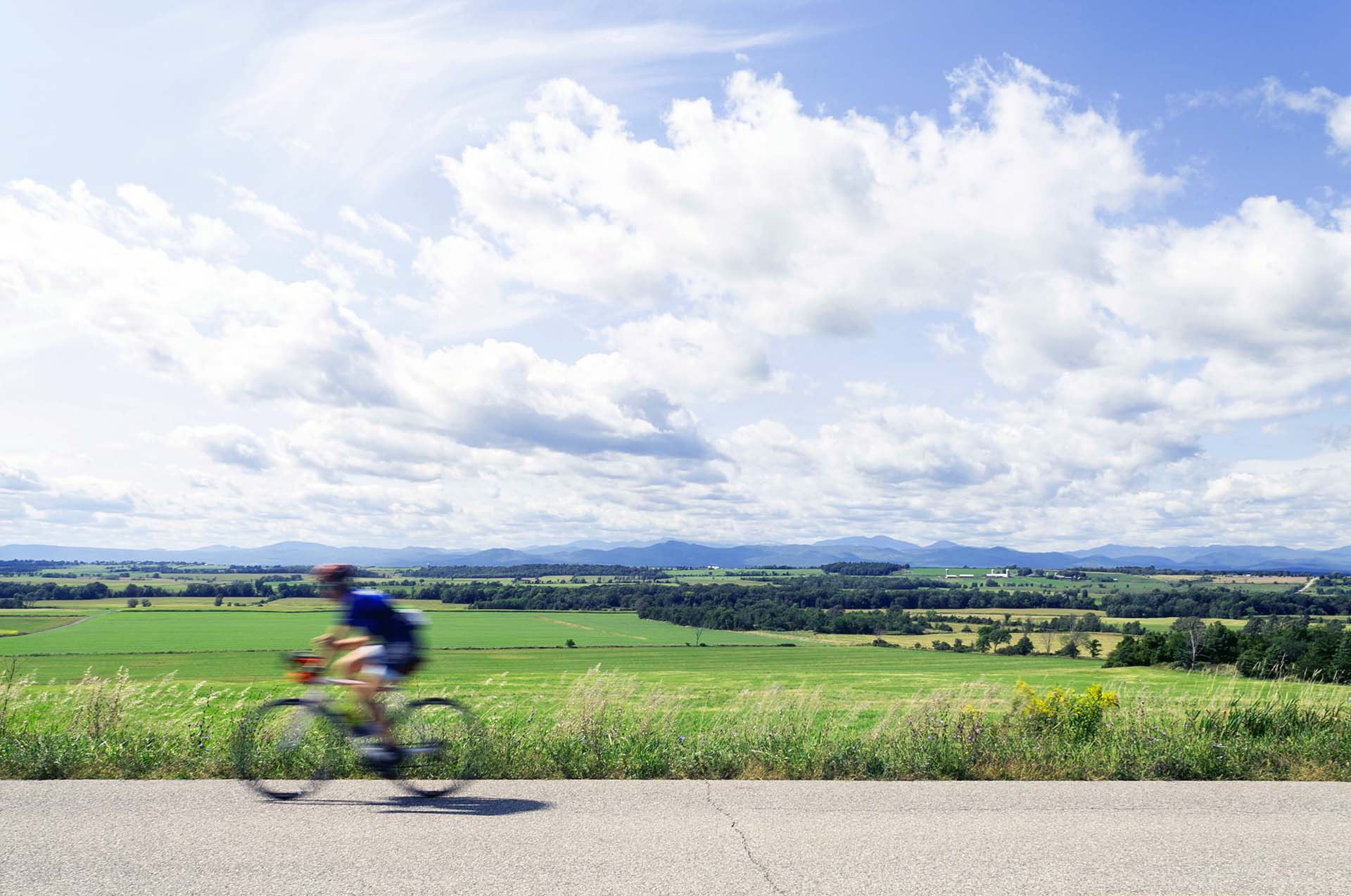 biker on road with mountain views